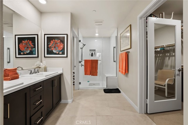 223 Carlow, Irvine, CA 92618 - full bath with a shower stall, baseboards, double vanity, tile patterned flooring, and a spacious closet
