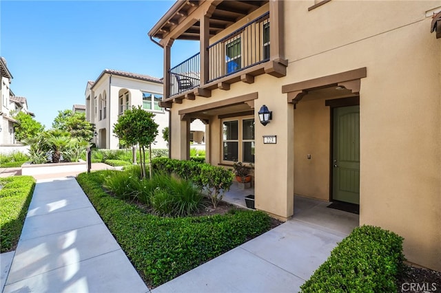 223 Carlow, Irvine, CA 92618 - doorway to property featuring a balcony and stucco siding