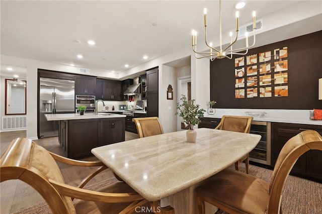 223 Carlow, Irvine, CA 92618 - dining room featuring beverage cooler, a chandelier, and recessed lighting