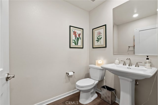 223 Carlow, Irvine, CA 92618 - half bath with baseboards, toilet, wood finished floors, and a sink