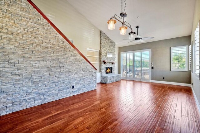 3313 Dehesa Rd Unit 85, El Cajon, CA 92019 - unfurnished living room with ceiling fan, high vaulted ceiling, wood finished floors, and a stone fireplace