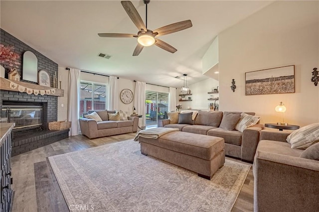 1266 Panorama Point Ct, Merced, CA 95340 - living area featuring wood finished floors, vaulted ceiling, a fireplace, and a ceiling fan
