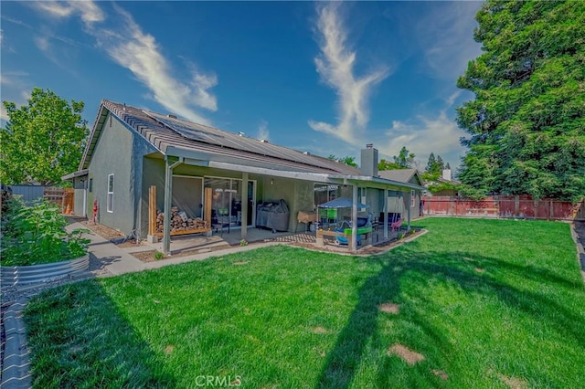 1266 Panorama Point Ct, Merced, CA 95340 - rear view of property featuring a patio, roof mounted solar panels, and stucco siding