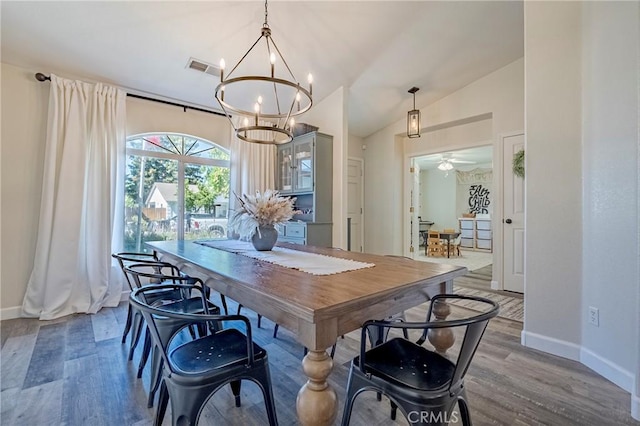 1266 Panorama Point Ct, Merced, CA 95340 - dining room with a chandelier, wood finished floors, baseboards, and lofted ceiling