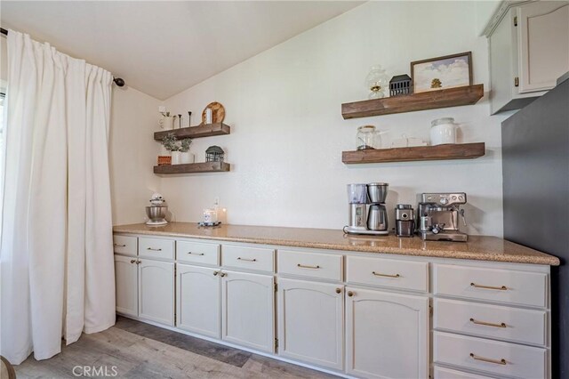 1266 Panorama Point Ct, Merced, CA 95340 - bar featuring freestanding refrigerator, light wood-style floors, and vaulted ceiling