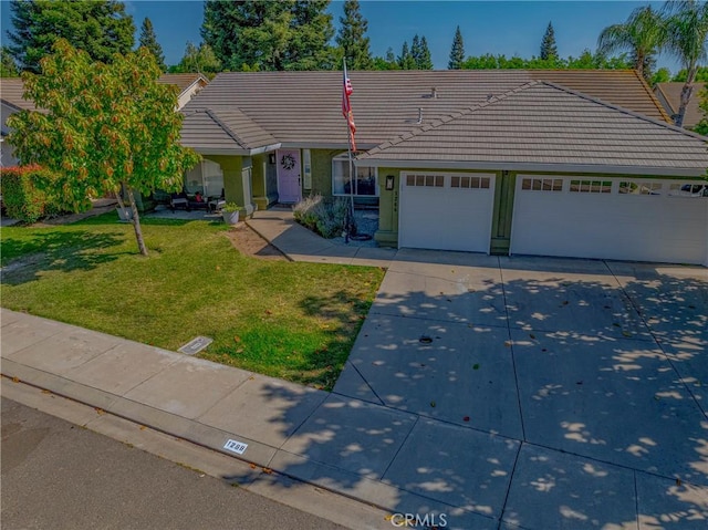 1266 Panorama Point Ct, Merced, CA 95340 - ranch-style house with a tile roof, driveway, an attached garage, a front lawn, and stucco siding