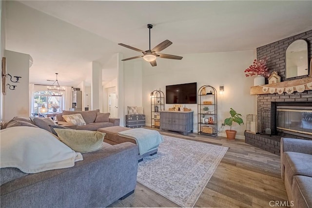 1266 Panorama Point Ct, Merced, CA 95340 - living area featuring ceiling fan, wood finished floors, lofted ceiling, and a brick fireplace