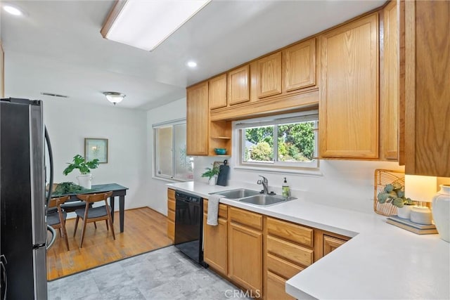 1000 W 11th Ave, Chico, CA 95926 - kitchen featuring freestanding refrigerator, black dishwasher, a sink, light countertops, and recessed lighting