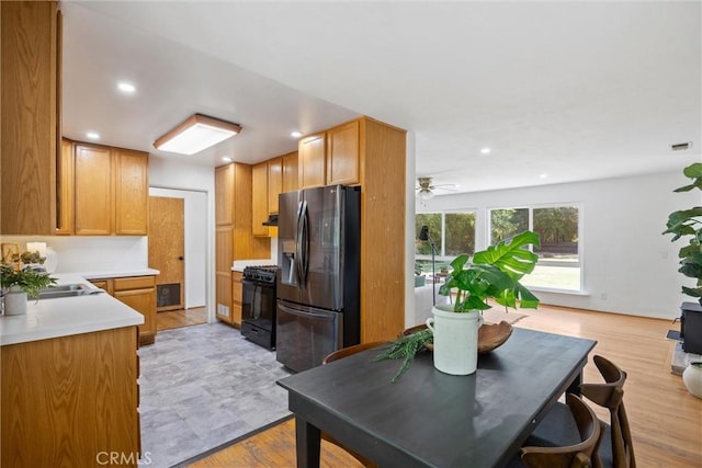 1000 W 11th Ave, Chico, CA 95926 - kitchen featuring stainless steel refrigerator with ice dispenser, black range with gas stovetop, light countertops, a sink, and recessed lighting