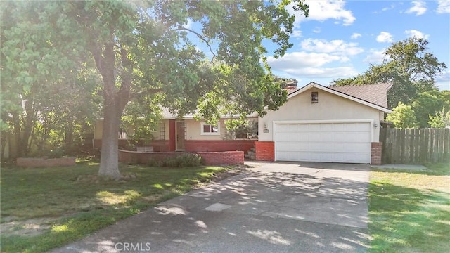 1000 W 11th Ave, Chico, CA 95926 - view of property hidden behind natural elements with driveway, an attached garage, brick siding, stucco siding, and a chimney