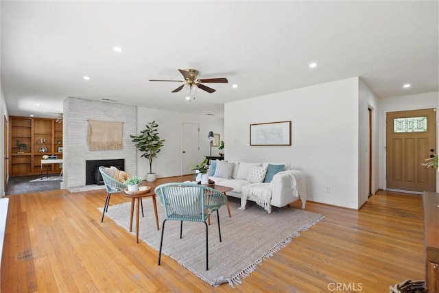 1000 W 11th Ave, Chico, CA 95926 - living area with light wood finished floors, ceiling fan, recessed lighting, a fireplace, and baseboards