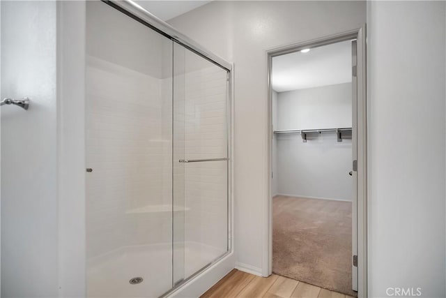 32939 Fleets Rd, Menifee, CA 92584 - bathroom with a shower stall, wood finished floors, and a spacious closet