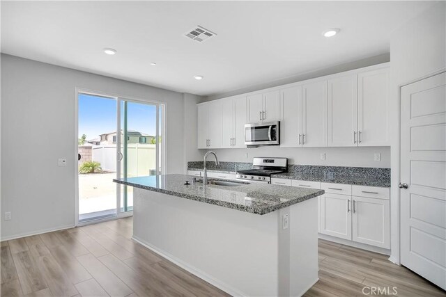 32939 Fleets Rd, Menifee, CA 92584 - kitchen with appliances with stainless steel finishes, stone countertops, white cabinetry, light wood finished floors, and recessed lighting