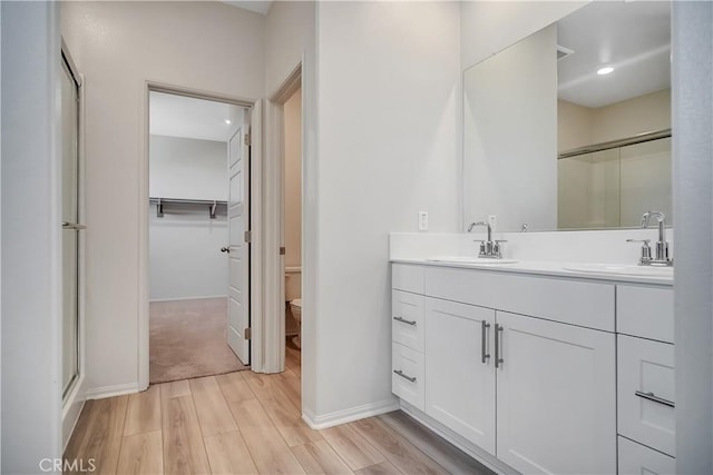 32939 Fleets Rd, Menifee, CA 92584 - full bathroom featuring wood finished floors, a stall shower, double vanity, and a walk in closet
