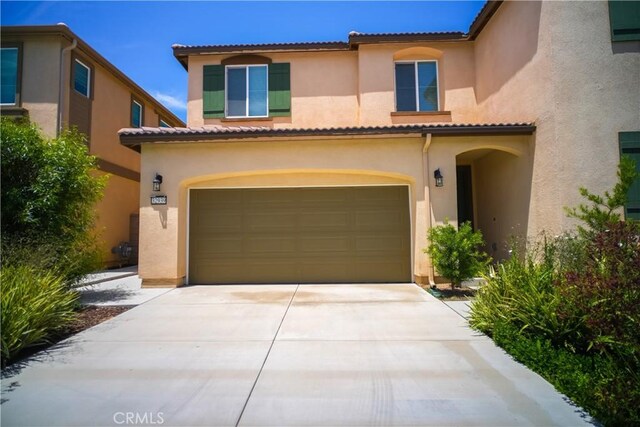 32939 Fleets Rd, Menifee, CA 92584 - mediterranean / spanish-style house with an attached garage, stucco siding, concrete driveway, and a tiled roof