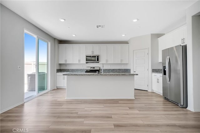 32939 Fleets Rd, Menifee, CA 92584 - kitchen featuring stainless steel appliances, white cabinets, light wood-type flooring, stone countertops, and recessed lighting