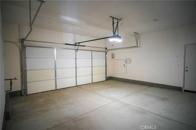 32939 Fleets Rd, Menifee, CA 92584 - garage with a garage door opener and baseboards
