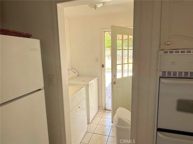 3401 Millbury Ave, Baldwin Park, CA 91706 - washroom with washing machine and dryer and light tile patterned floors