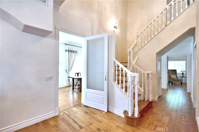 2767 Saleroso Dr, Rowland Heights, CA 91748 - stairway featuring hardwood / wood-style flooring, a towering ceiling, and baseboards