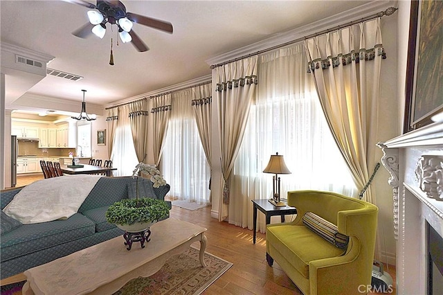 2767 Saleroso Dr, Rowland Heights, CA 91748 - living area with crown molding, ceiling fan, a chandelier, and light wood-style flooring