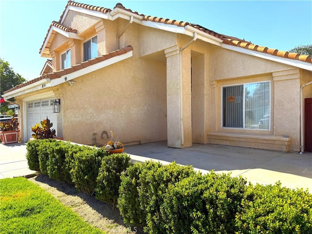 28594 Moon Shadow Dr, Menifee, CA 92584 - view of front facade with stucco siding and a tile roof