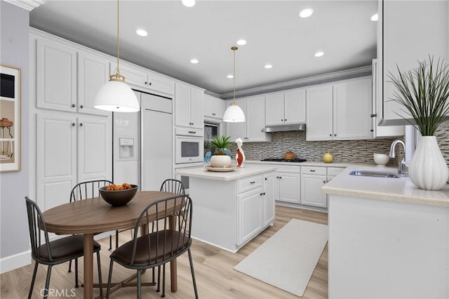 23922 Lakeside Rd, Valencia, CA 91355 - kitchen with backsplash, a sink, white cabinetry, oven, and recessed lighting
