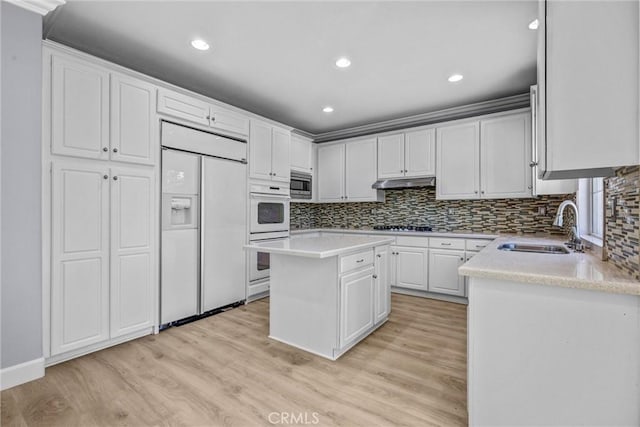 23922 Lakeside Rd, Valencia, CA 91355 - kitchen featuring built in appliances, a sink, light wood-style flooring, backsplash, and recessed lighting