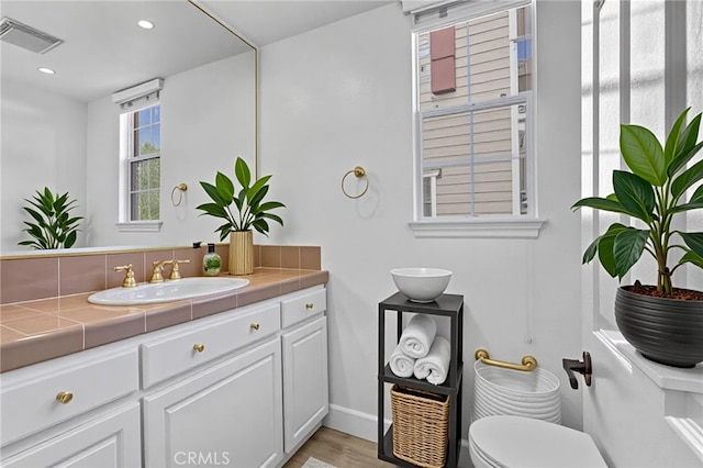 23922 Lakeside Rd, Valencia, CA 91355 - bathroom featuring vanity, baseboards, toilet, wood finished floors, and recessed lighting