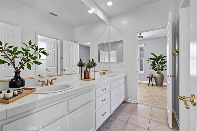 23922 Lakeside Rd, Valencia, CA 91355 - bathroom with double vanity, tile patterned flooring, baseboards, and recessed lighting