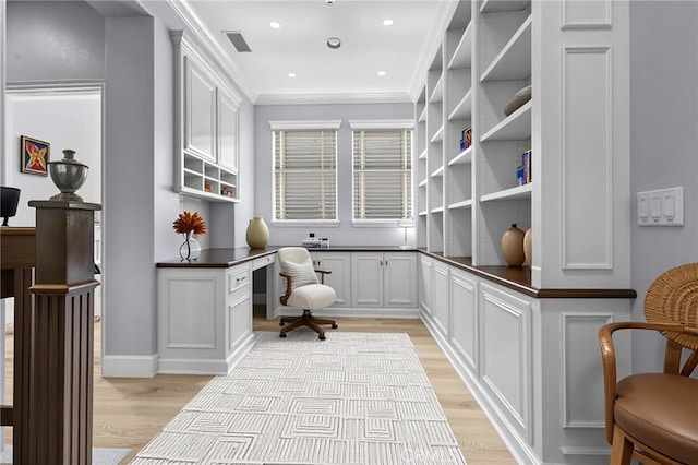 23922 Lakeside Rd, Valencia, CA 91355 - home office featuring light wood-style floors, built in desk, ornamental molding, and recessed lighting
