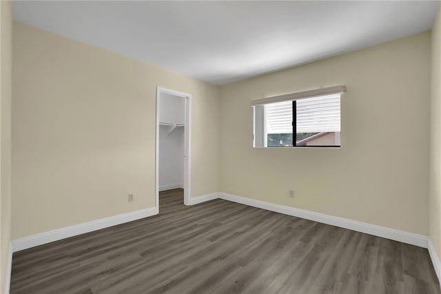 1903 Tomas Ct, Rowland Heights, CA 91748 - unfurnished bedroom with dark wood finished floors, baseboards, a closet, and a spacious closet