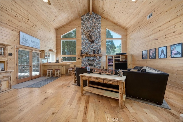 10820 Bonita Way, Wofford Heights, CA 93285 - living room featuring high vaulted ceiling, wood-type flooring, wooden ceiling with exposed beams, a fireplace, and wooden walls