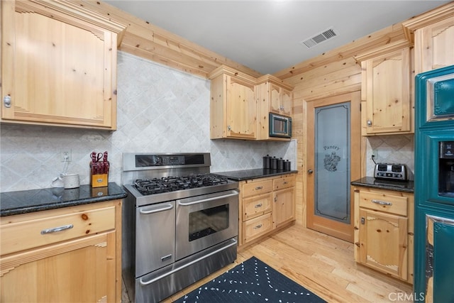 10820 Bonita Way, Wofford Heights, CA 93285 - kitchen with double oven range, black microwave, light brown cabinetry, and backsplash