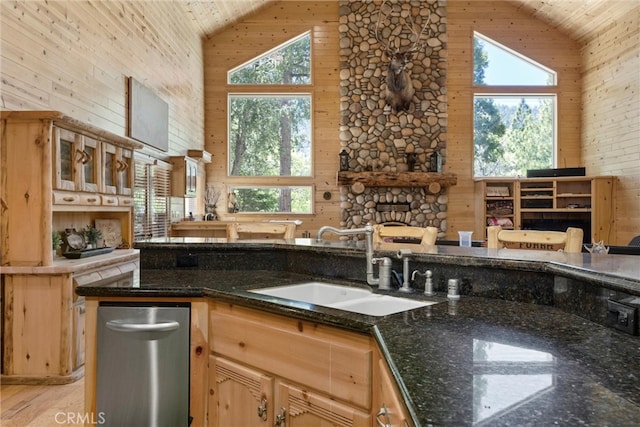 10820 Bonita Way, Wofford Heights, CA 93285 - kitchen with high vaulted ceiling, a sink, wooden walls, plenty of natural light, and a fireplace