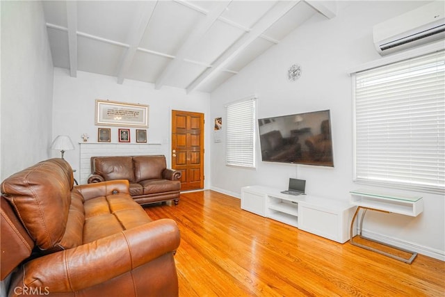 521 W Erna Ave, La Habra, CA 90631 - living room featuring an AC wall unit, light wood-style flooring, and baseboards