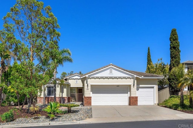 435 Sandalwood Ct, Encinitas, CA 92024 - view of front of home with brick siding, a garage, and driveway
