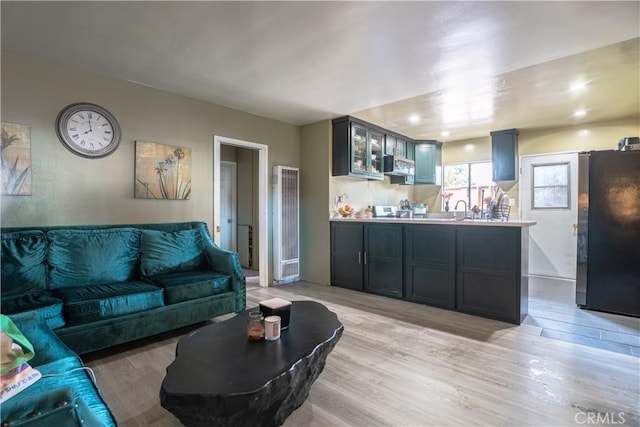 11737 Bellman Ave, Downey, CA 90241 - living room with light wood finished floors and a heating unit