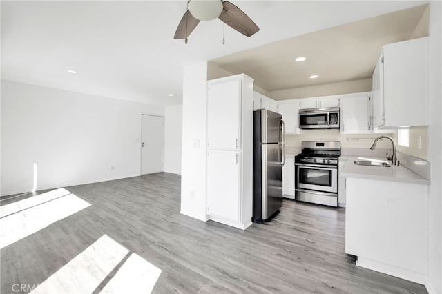 4406 Cahuenga Blvd, Toluca Lake, CA 91602 - kitchen with stainless steel appliances, a sink, a ceiling fan, open floor plan, and light countertops