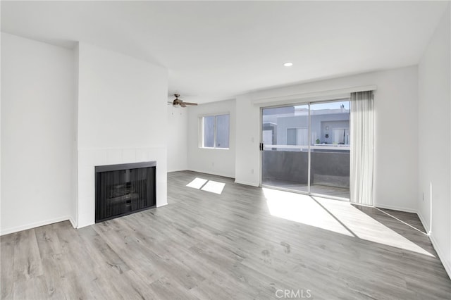 4406 Cahuenga Blvd, Toluca Lake, CA 91602 - unfurnished living room featuring a ceiling fan, wood finished floors, baseboards, a tiled fireplace, and recessed lighting