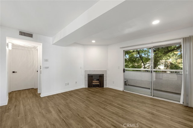 4406 Cahuenga Blvd, Toluca Lake, CA 91602 - unfurnished living room featuring wood finished floors, a high end fireplace, baseboards, and recessed lighting