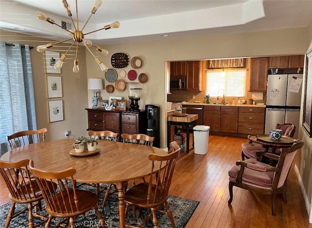 619 C St, Lemoore, CA 93245 - dining space featuring light wood-style floors and a chandelier