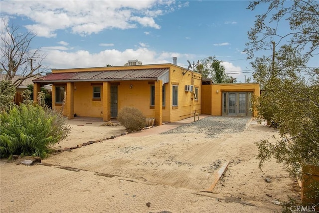 6155 Cahuilla Ave Unit 29, Palms, CA 92277 - view of front of home featuring french doors and driveway