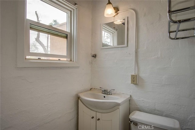 6155 Cahuilla Ave Unit 29, Palms, CA 92277 - half bath featuring vanity, healthy amount of natural light, and toilet
