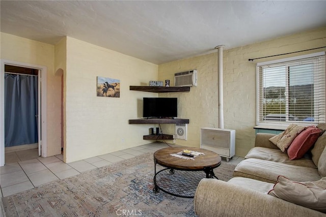 6155 Cahuilla Ave Unit 29, Palms, CA 92277 - living room with tile patterned floors, an AC wall unit, and arched walkways