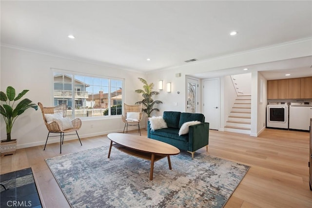 4920 Island View St, Oxnard, CA 93035 - living room with washer and dryer, ornamental molding, stairs, light wood finished floors, and baseboards