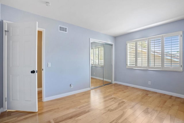 3442 Celinda Dr, Carlsbad, CA 92008 - unfurnished bedroom with light wood finished floors and a closet