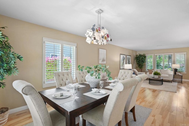 3442 Celinda Dr, Carlsbad, CA 92008 - dining area with a chandelier and light wood-style floors