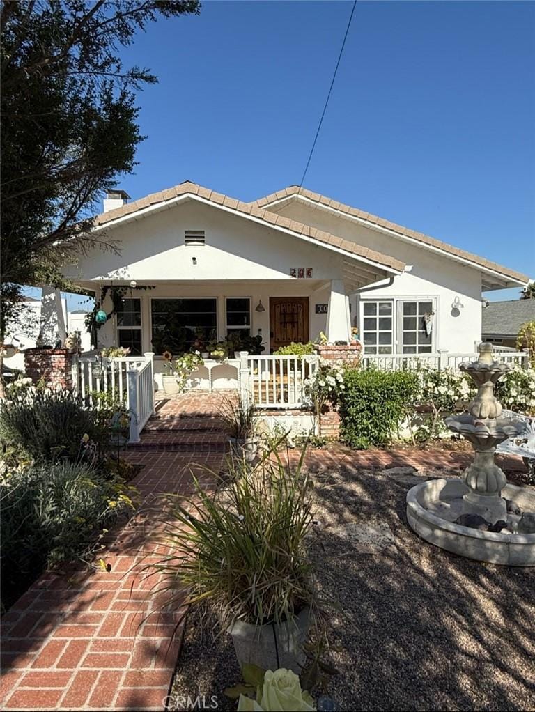 206 S Wisconsin St, Fallbrook, CA 92028 - back of house with stucco siding, covered porch, and a chimney