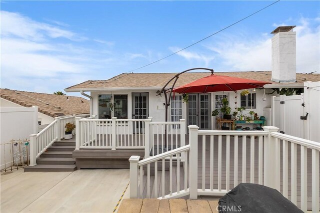 206 S Wisconsin St, Fallbrook, CA 92028 - rear view of house with a wooden deck, a chimney, a shingled roof, and stucco siding