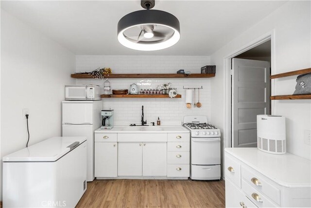 206 S Wisconsin St, Fallbrook, CA 92028 - kitchen with white appliances, a sink, open shelves, decorative backsplash, and light countertops